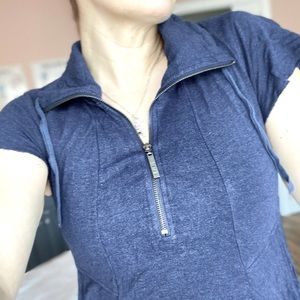 Cute blue mini with huge angled pockets and flutter sleeves and a zip front.